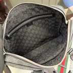 Interior of GG monogram bag with zippered pocket and dark lining.