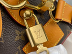 Bag lock clasp with gold-tone padlock on tan leather strap
