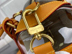 Gold D-ring and clasp hardware with tan leather strap on monogram handbag