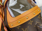 Tan leather trim with stitched panel and gold rivets on monogram handbag