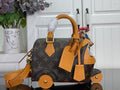 Louis Vuitton monogram handbag with tan leather handles, straps, and gold hardware
