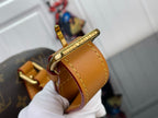 Top-handle bag strap loop with gold-tone hardware and tan leather edge