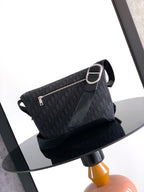 Dior small shoulder bag with top zipper, patterned fabric, and adjustable strap