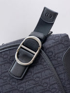 Dior logo strap loop with silver buckle on patterned bag