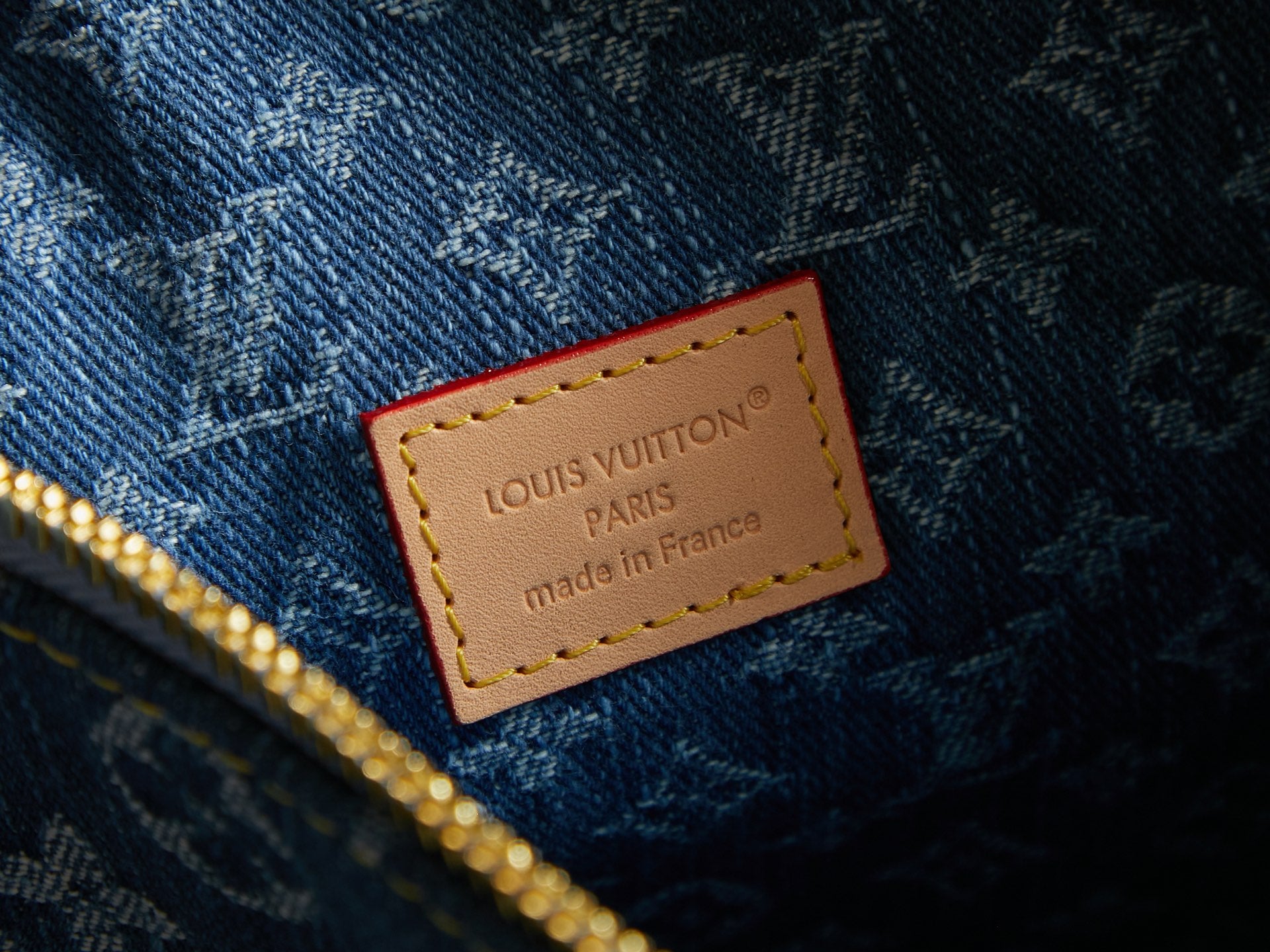 Blue monogram bag label patch reading Louis Vuitton Paris, made in France