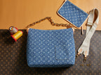 Blue monogram shoulder bag with top handle and gold chain strap
