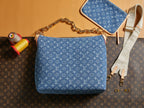 Blue monogram shoulder bag with curved front and detachable crossbody strap