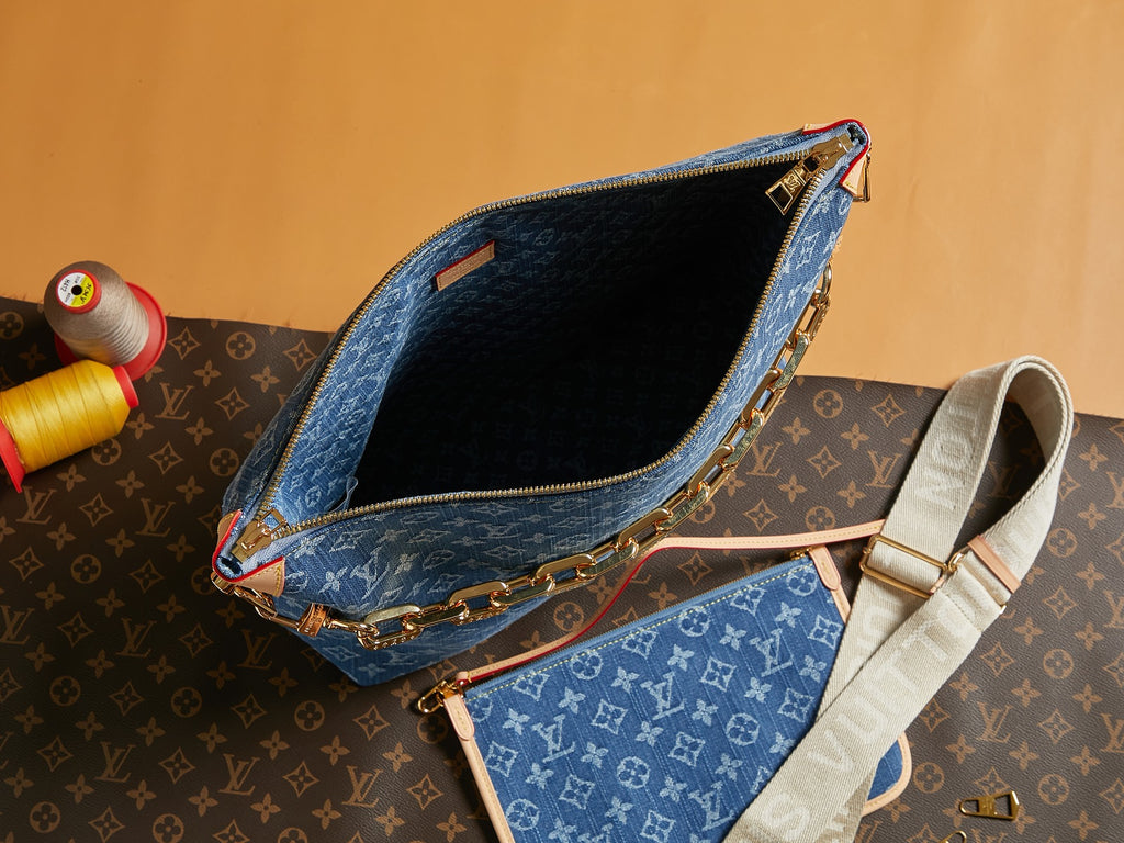 Open blue monogram bag interior with gold zipper edge and crossbody strap