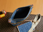 Open blue monogram bag interior with gold zipper edge and crossbody strap