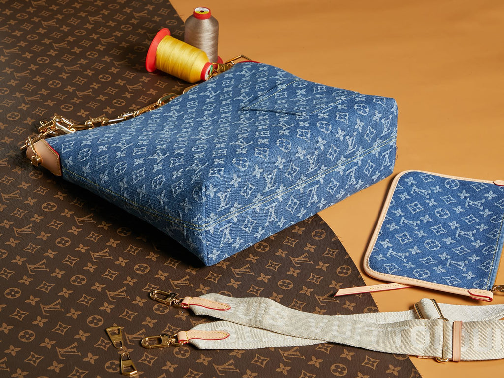 Blue monogram handbag with gold chain strap and front zipper opening