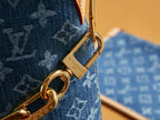 Gold clasp and keyring on blue monogram bag strap with engraved hardware
