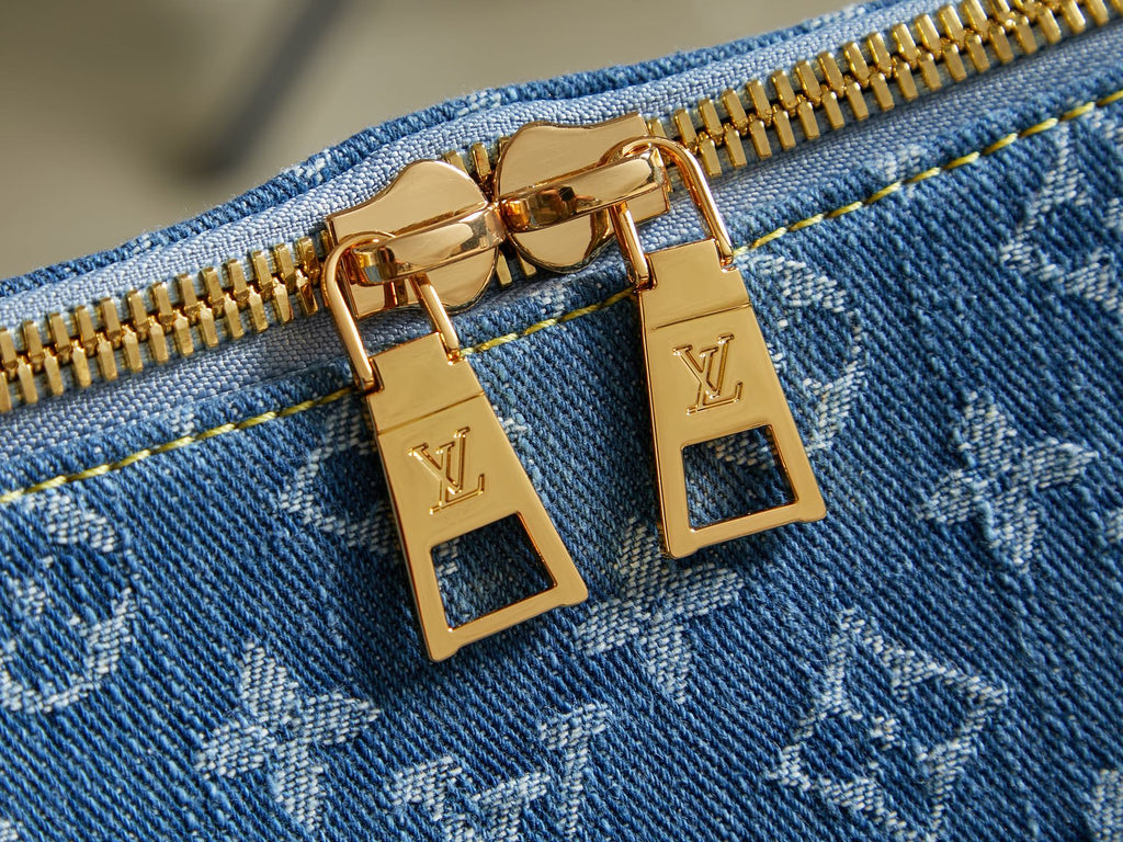 Blue monogram bag with gold zipper pulls and LV padlock-style hardware
