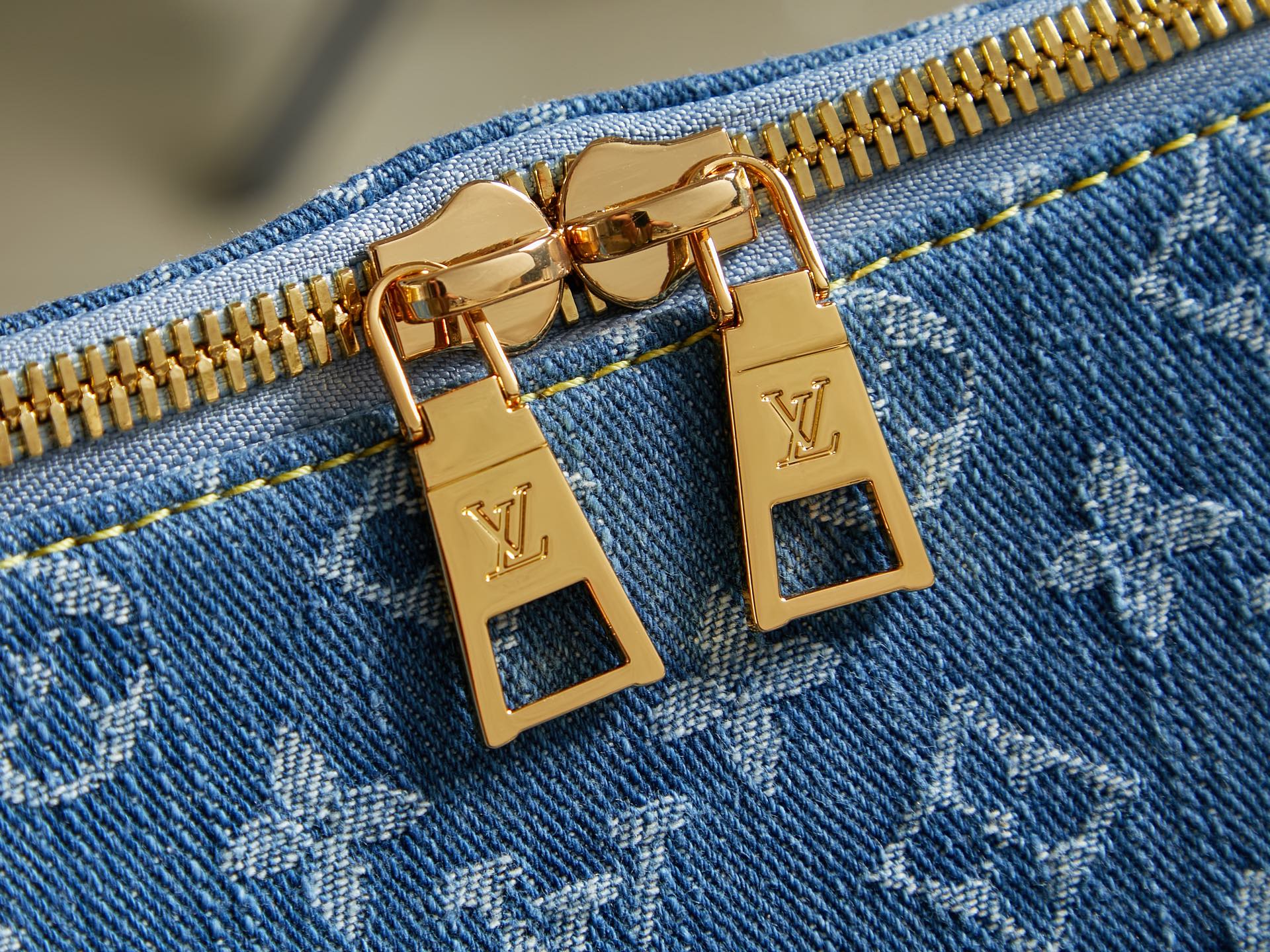 Blue monogram bag with gold zipper pulls and LV padlock-style hardware
