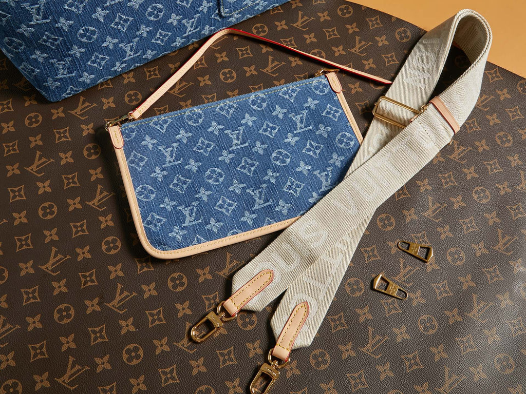Blue monogram crossbody bag with wide white strap and gold zipper trim