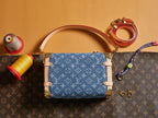 Louis Vuitton handbag with blue monogram canvas front panel, tan trim, and top handles