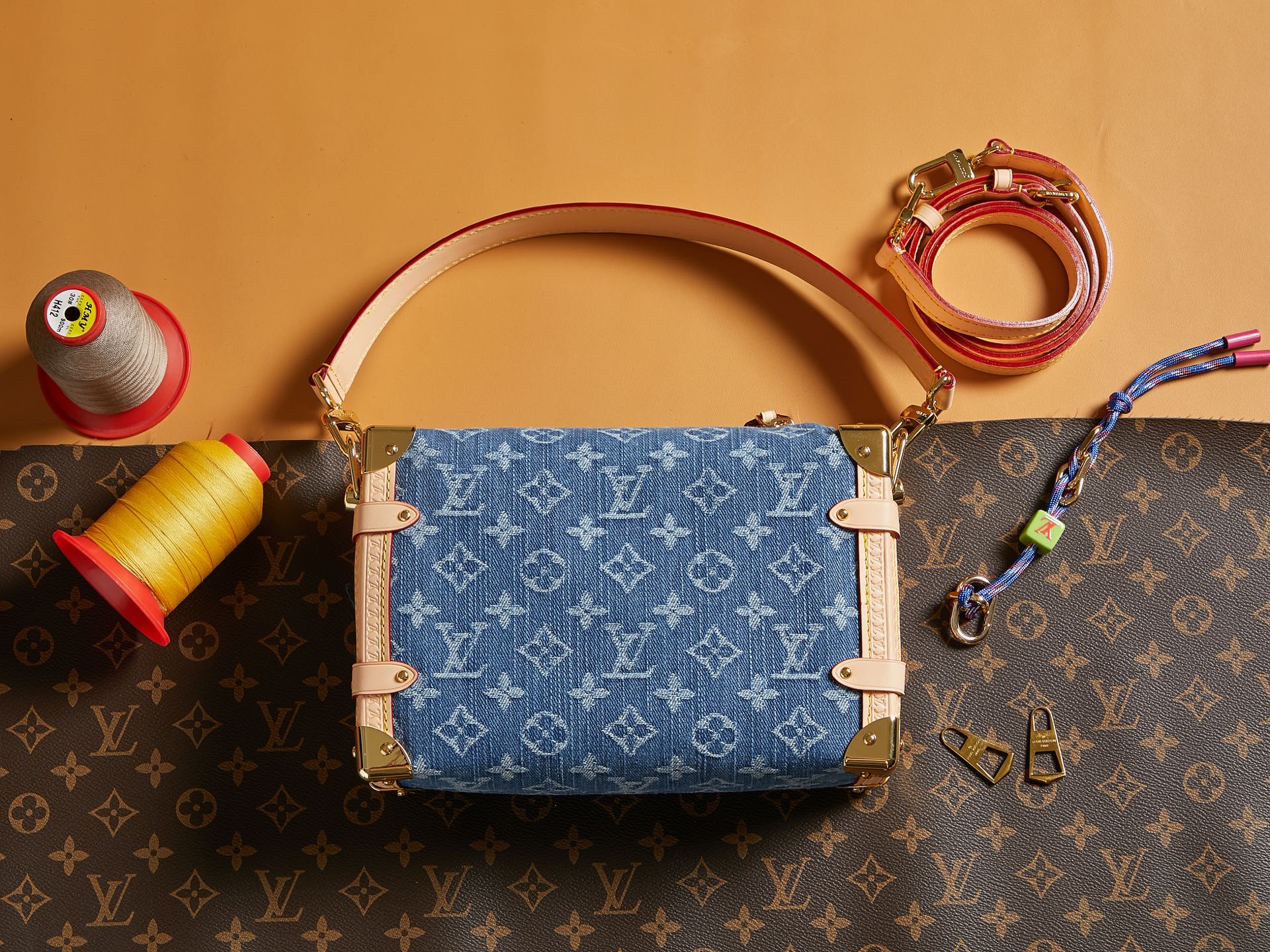 Louis Vuitton handbag with blue monogram canvas front panel, tan trim, and top handles