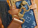 Louis Vuitton handbag clasp and D-ring on tan leather trim over blue monogram canvas