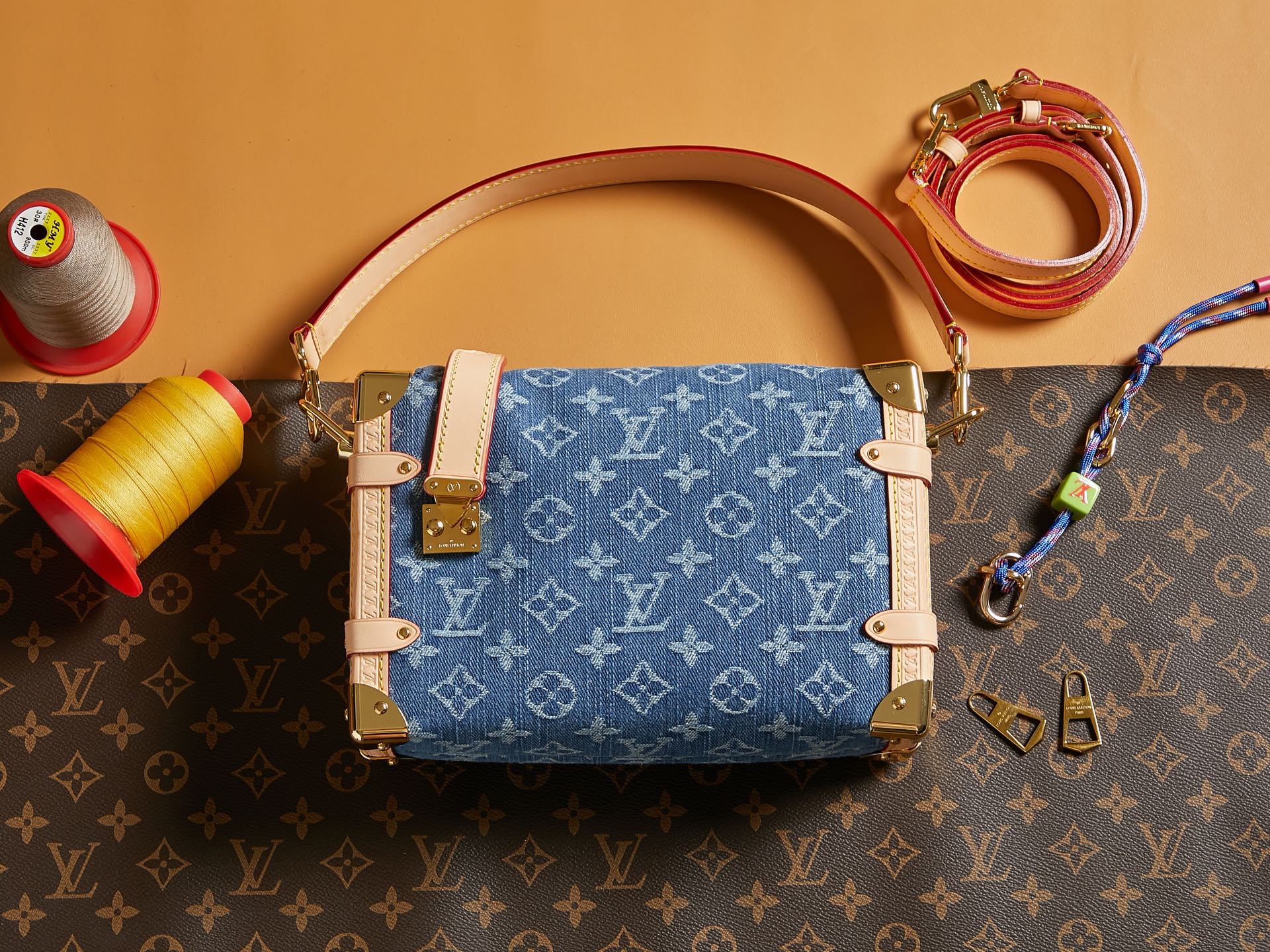 Louis Vuitton handbag with blue monogram canvas, tan leather trim, and top handles