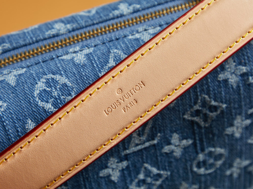 Louis Vuitton leather trim strip with tan stitching on blue monogram canvas bag
