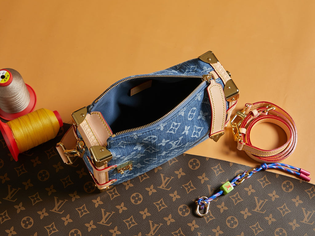 Louis Vuitton handbag open top with blue monogram canvas, tan trim, and gold zipper hardware