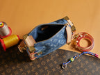 Louis Vuitton handbag open top with blue monogram canvas, tan trim, and gold zipper hardware