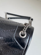 Black leather flap shoulder bag with YSL charm clasp and chain strap