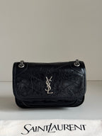 Black leather flap shoulder bag with chain strap, YSL logo, and embossed texture