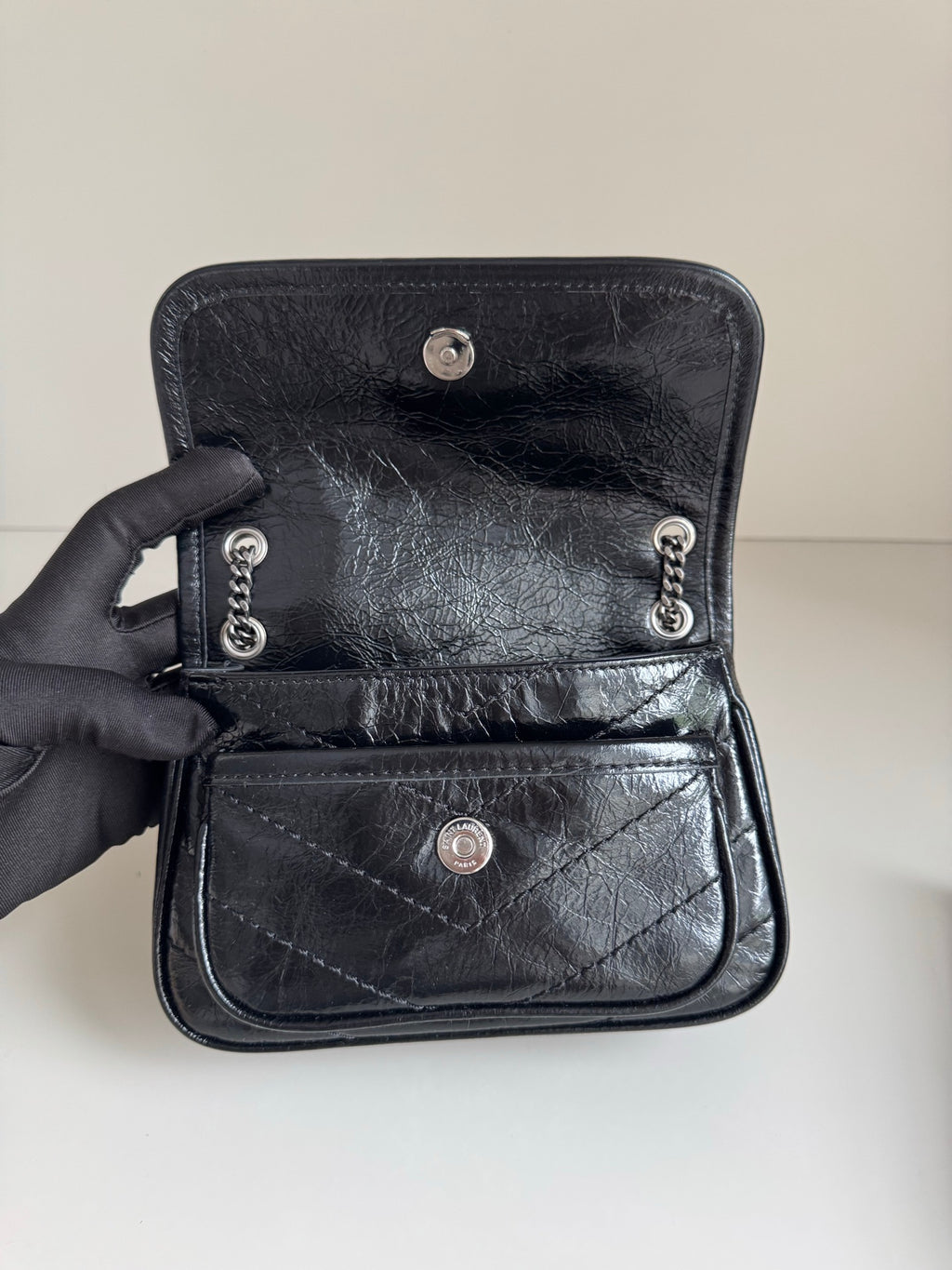 Black leather mini bag with snap front flap and chain strap hardware