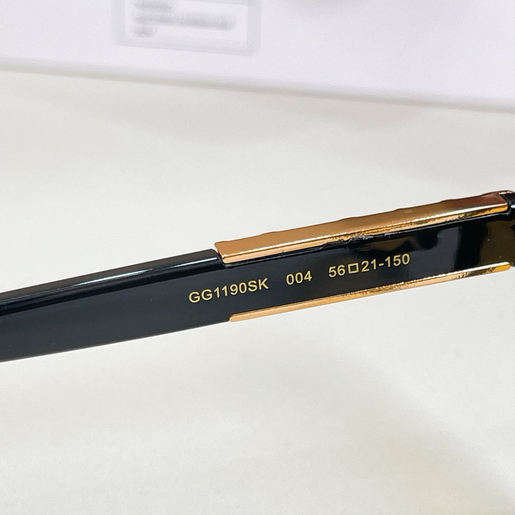 Sunglasses temple with printed model numbers on black, gold trim