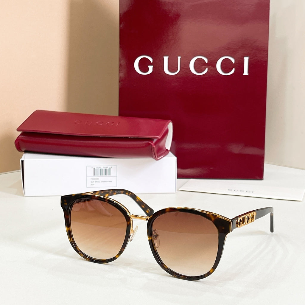Sunglasses with tortoiseshell frames and brown tinted lenses, gold logo temple tips