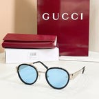 Round sunglasses with black frames and light blue-tinted lenses