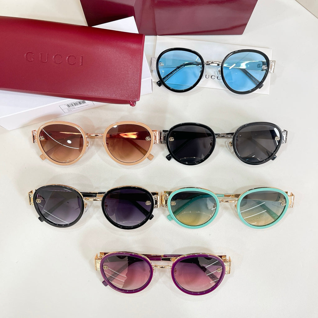 Assorted round sunglasses with colored frames and tinted lenses on display