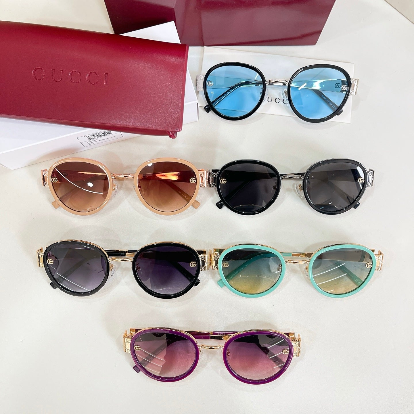 Assorted round sunglasses with colored frames and tinted lenses on display