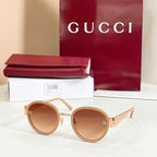 Round sunglasses with light gold frames and brown-tinted lenses