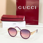 Round sunglasses with gold frames and purple-tinted lenses