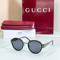 Round sunglasses with black frames, dark lenses, and gold logo details