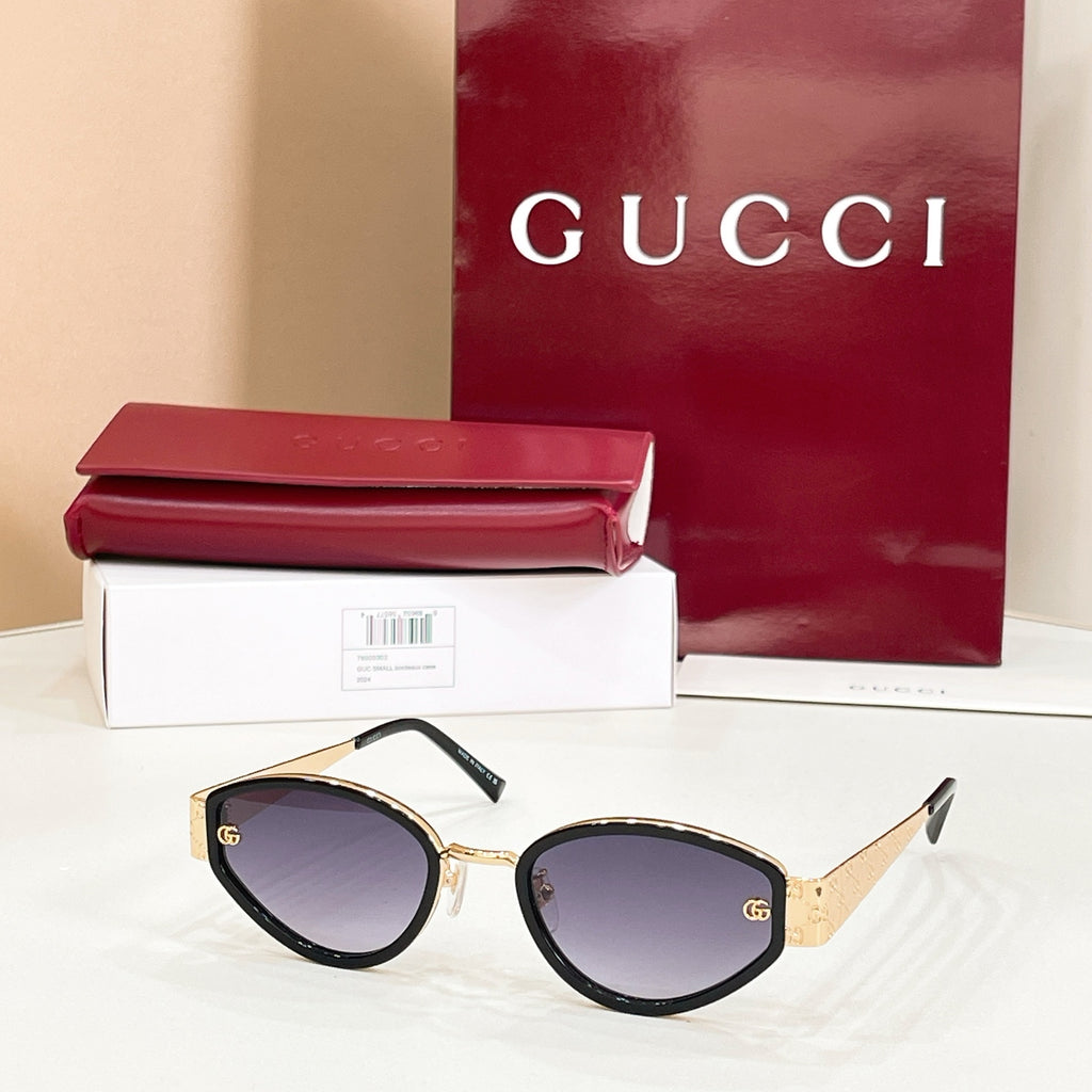 Sunglasses with gold-trim black frame and dark lenses