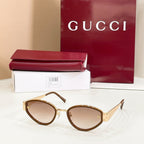 Sunglasses with gold frame and brown lenses