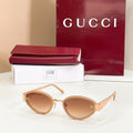 Sunglasses with gold frame and warm brown lenses