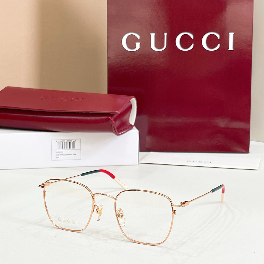 Rectangular eyeglasses with rose-gold frame and red/green temple accents