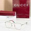 Rectangular eyeglasses with silver frame and green temple accents