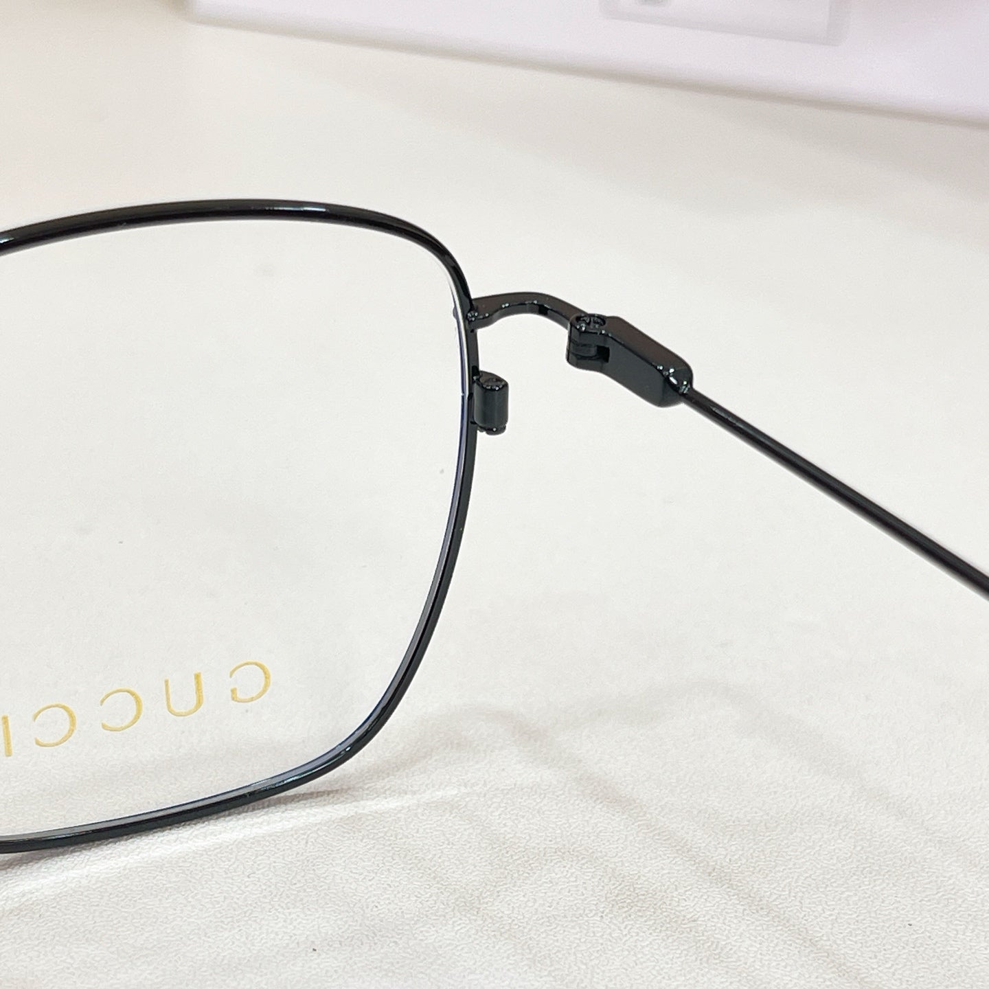 Black eyeglass temple with textured hinge and adjustable arm joint
