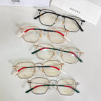 Assorted rectangular eyeglasses with mixed frames and red, green, and blue temple accents