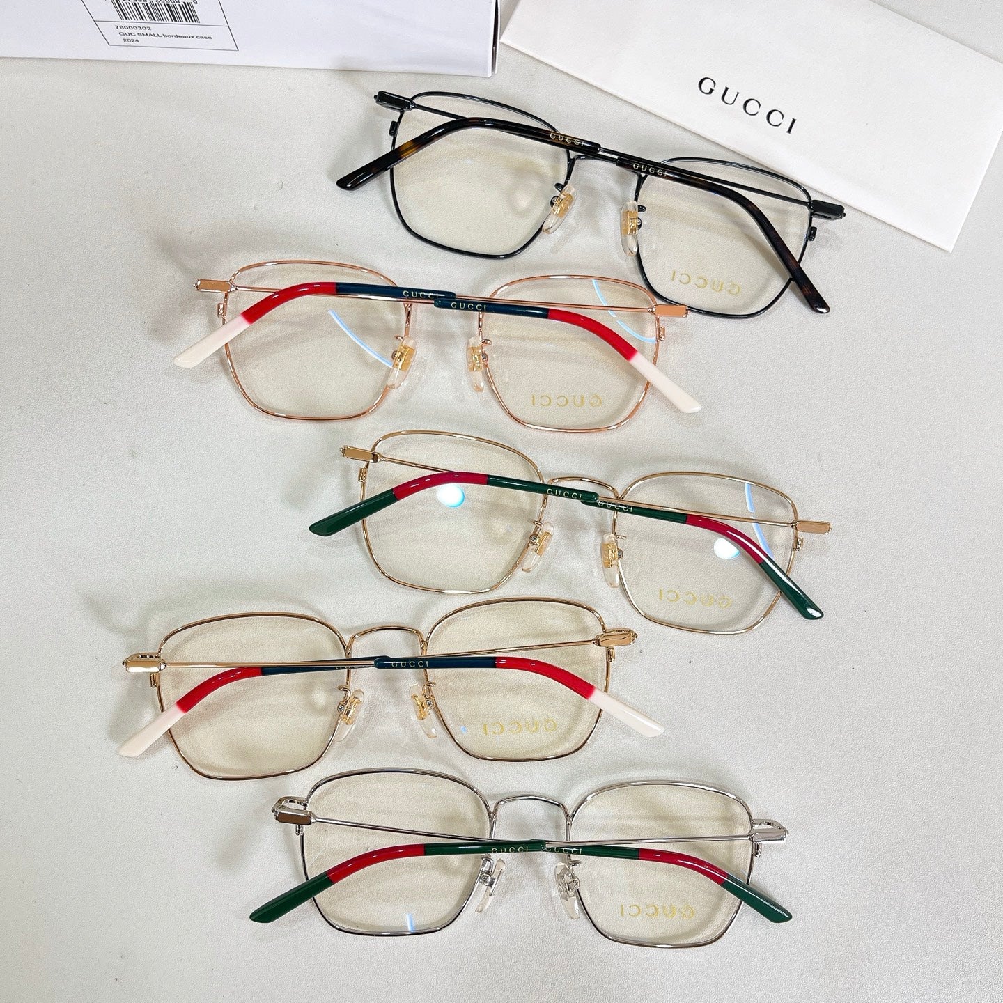 Assorted rectangular eyeglasses with mixed frames and red, green, and blue temple accents