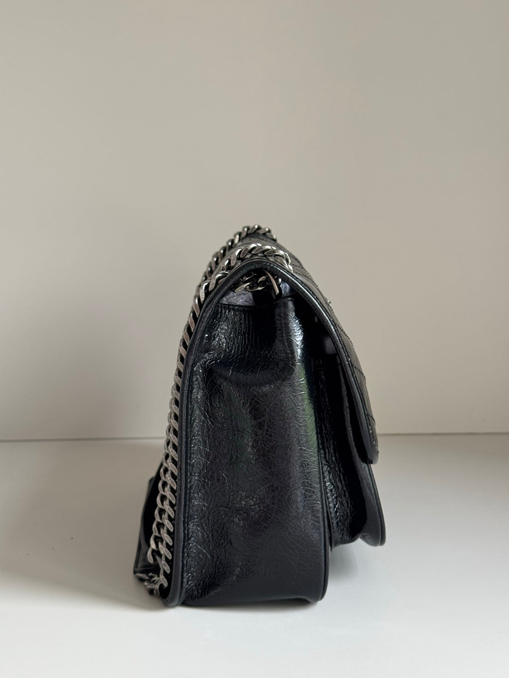 Saint Laurent black leather mini flap bag with chain strap on side