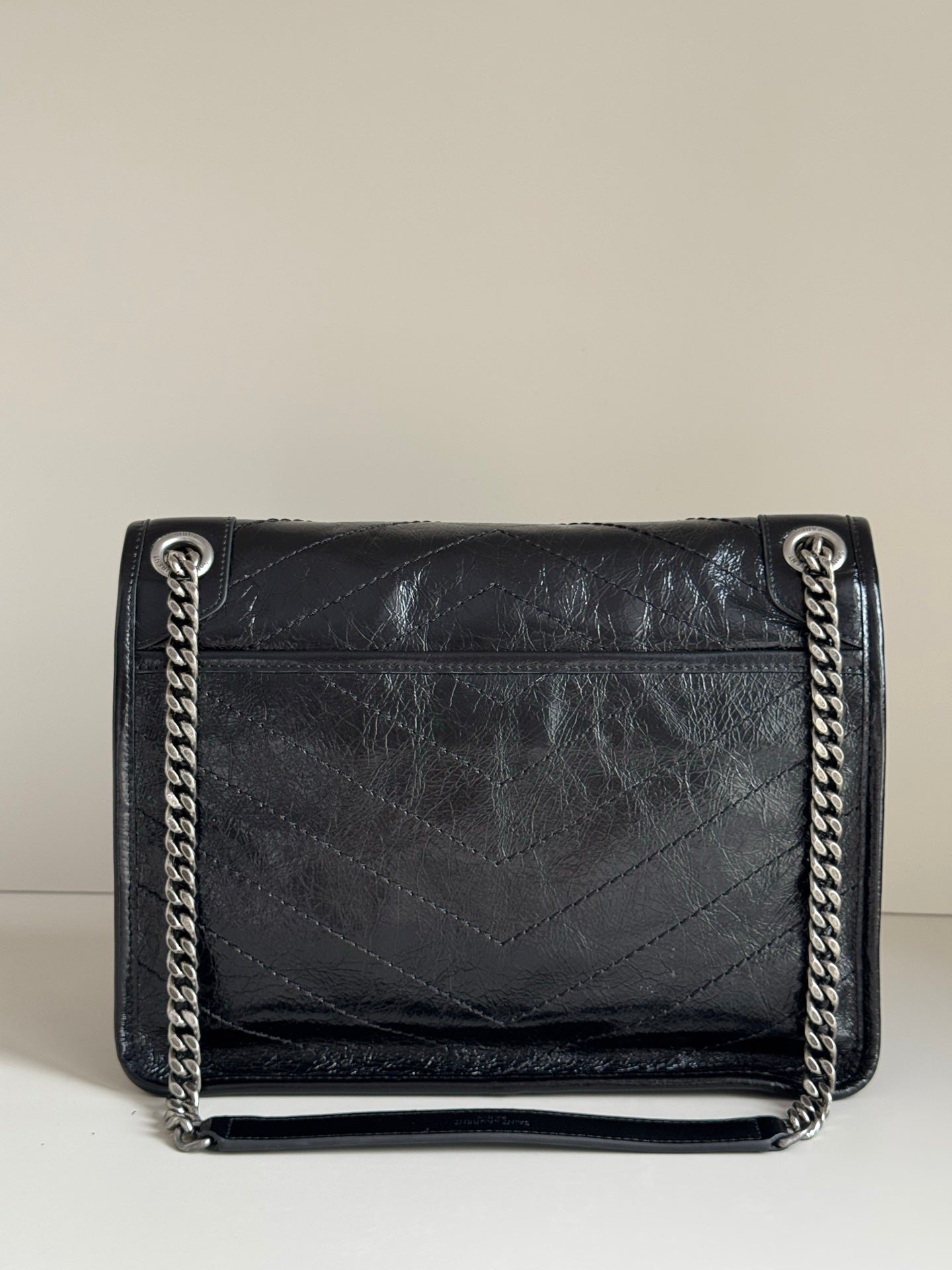 Saint Laurent black leather flap bag with chain shoulder straps and stitched front