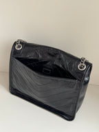 Saint Laurent black leather mini bag interior with side pocket and quilted lining