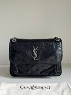 Saint Laurent small black leather flap bag with YSL logo and chain strap
