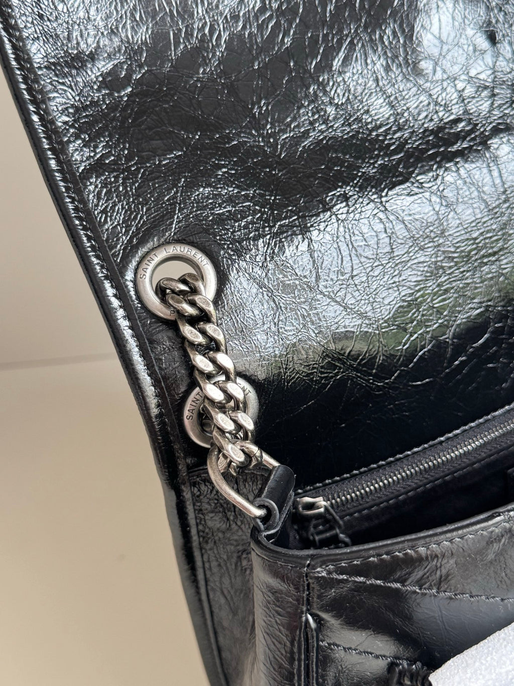 Saint Laurent black leather flap with chain detail and zipper pull
