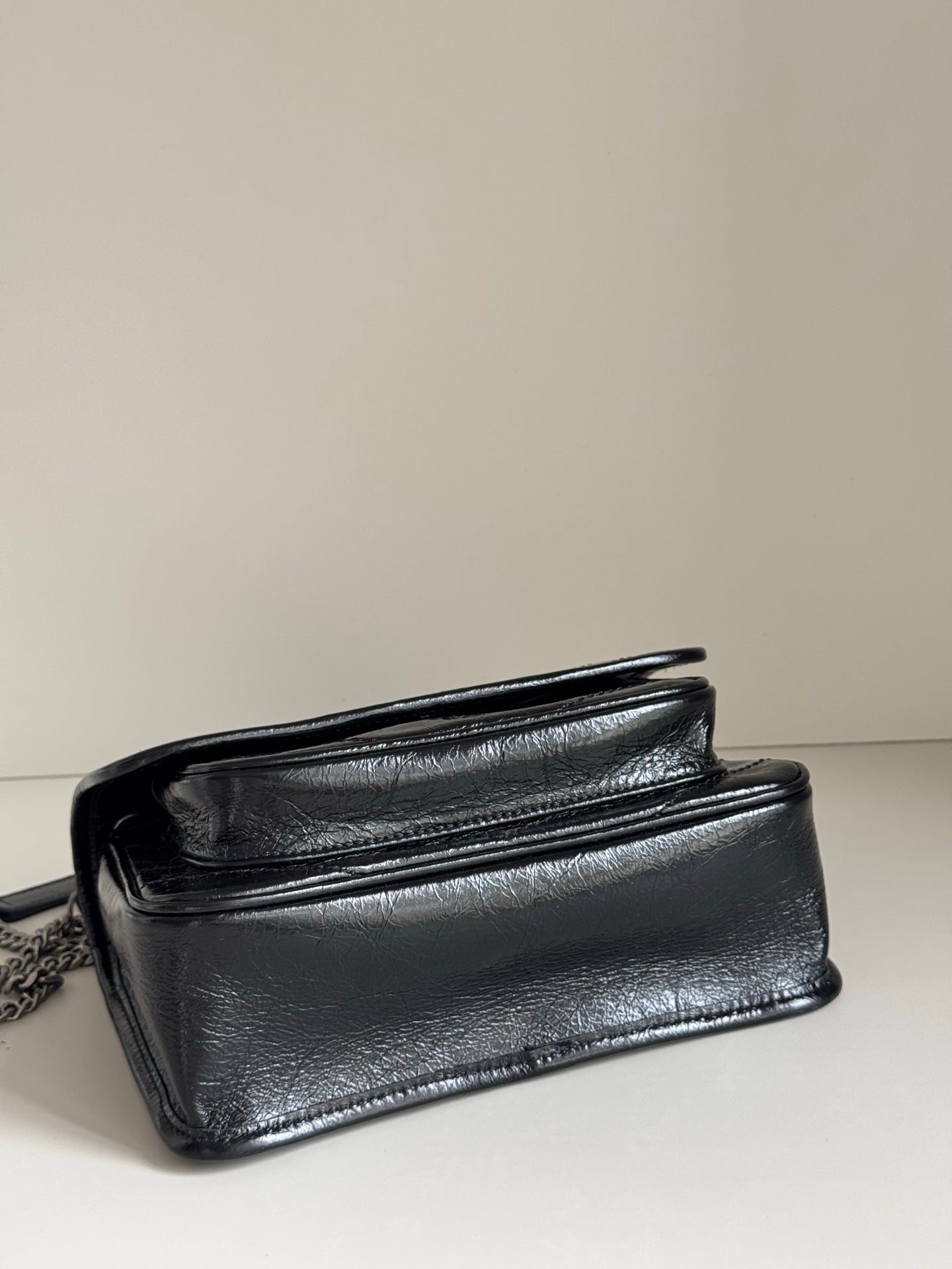 YSL dark leather mini bag with chain strap and foldover front pocket